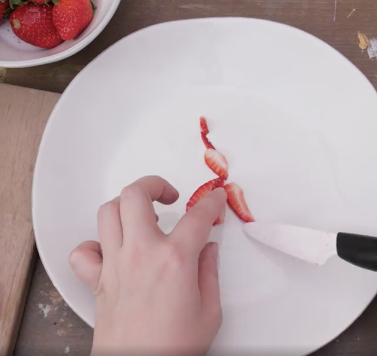 Rodgers assembling her strawberry pieces on a plate.