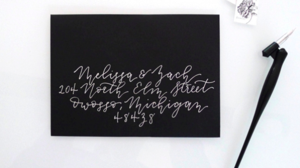This monoline calligraphy, done in white ink on a black envelope, gives this project a modern look.