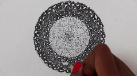 Teacher Meenakshi Chinniah demonstrates how to create the center of a sunflower.