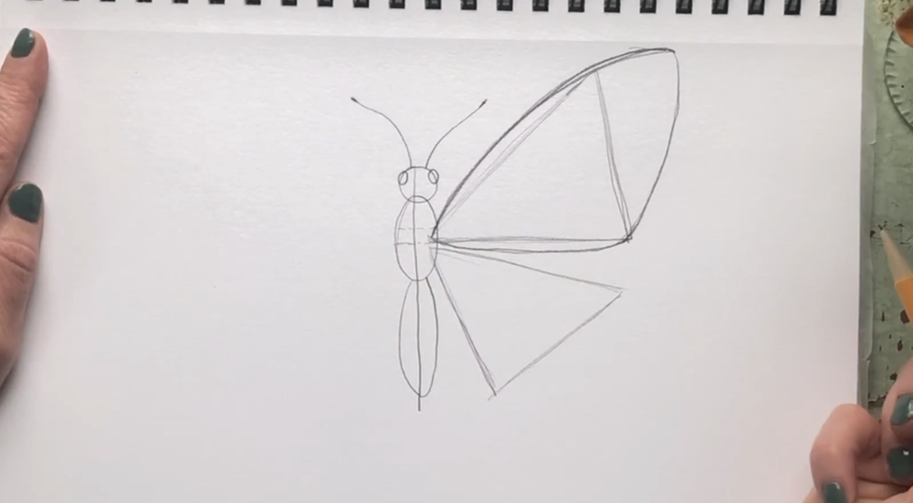 Start the wing outline by drawing a curved line above the top triangle. 