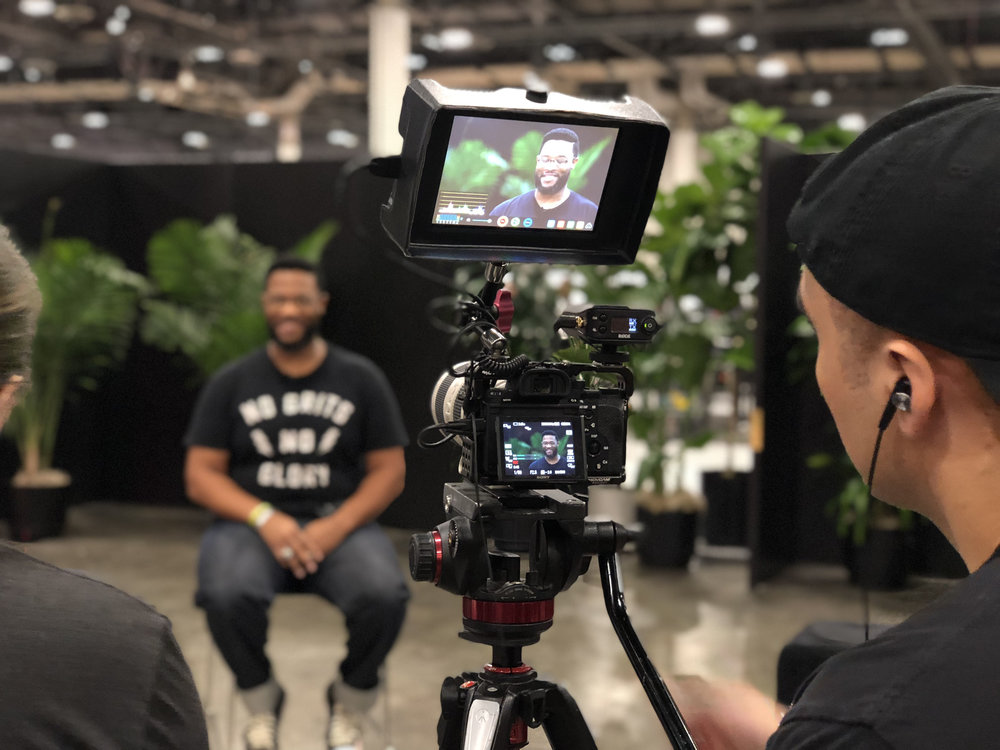 Reuben being interviewed in a No Grits No Glory shirt of his own design