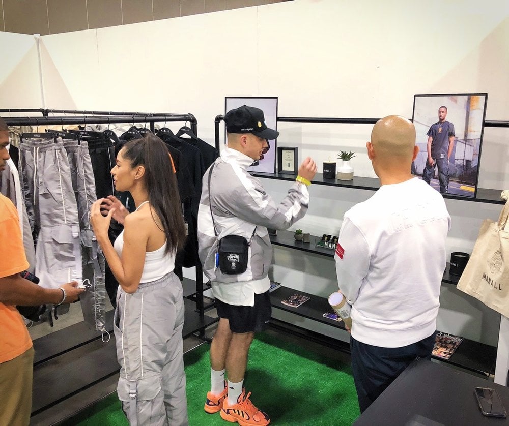 Jeff Staple (far right) chats with Tyler in the M A N A L L booth