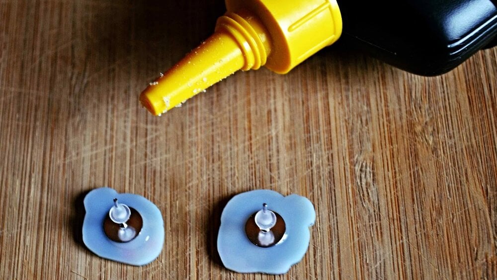 The finished plastic pieces being glued onto the flat front part of the earring.