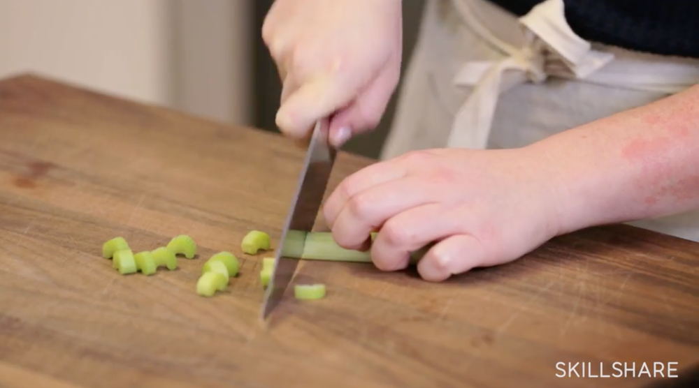 Slice celery using a pushing and pulling motion.