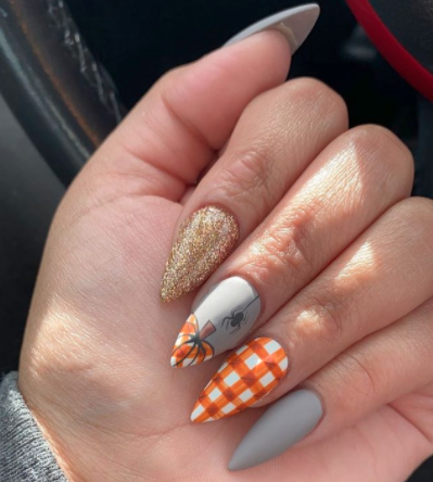 Image via Instagram Orange details can spice up an otherwise neutral fall manicure.