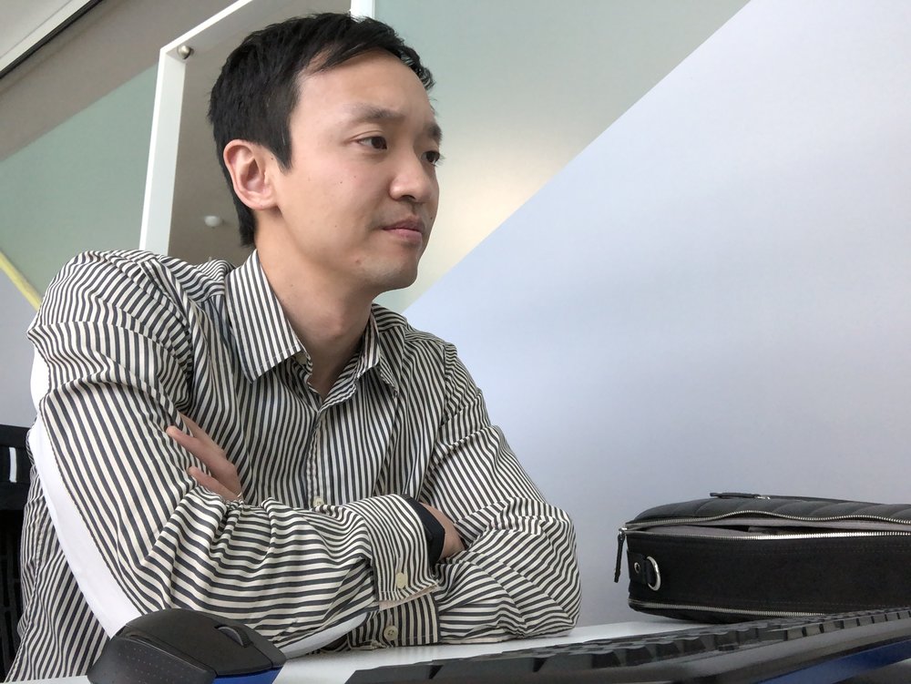 John Kim, pictured, video editing at his desk (image courtesy of John Kim)
