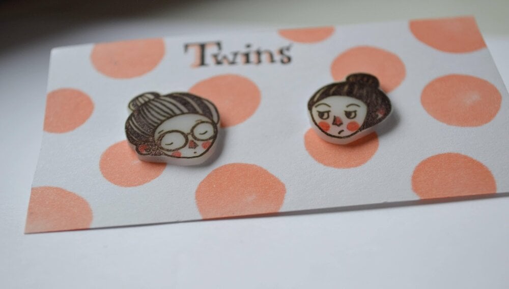 Finished illustrated earrings ready to be worn.