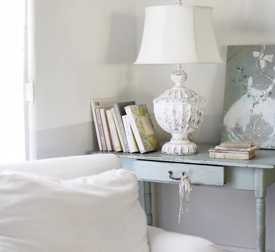 Vintage design elements in a room, including distressed furniture and antique books.