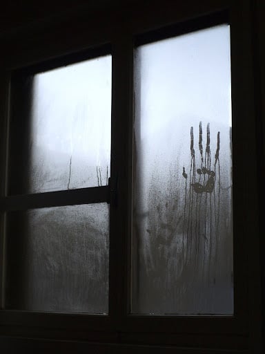 misty window with handprint