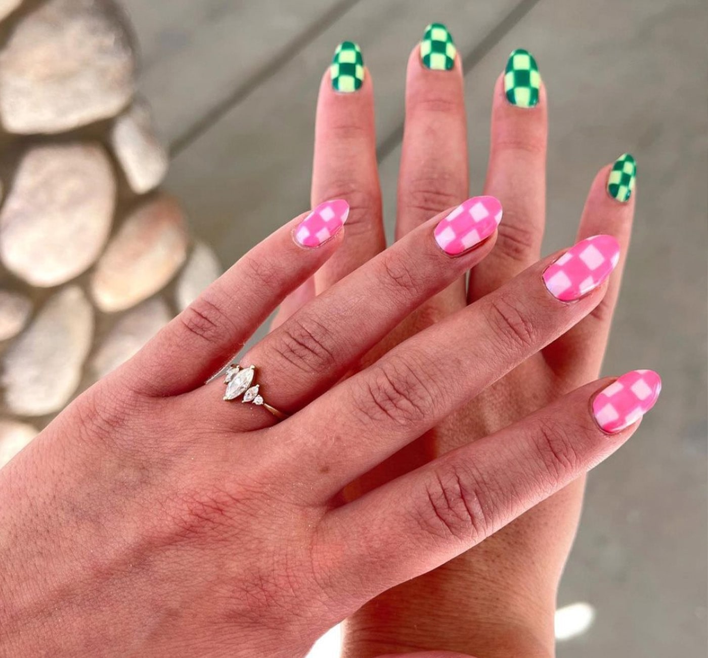 Nails in a checkered pattern. One hand is two tone pink and the other is two tone green.