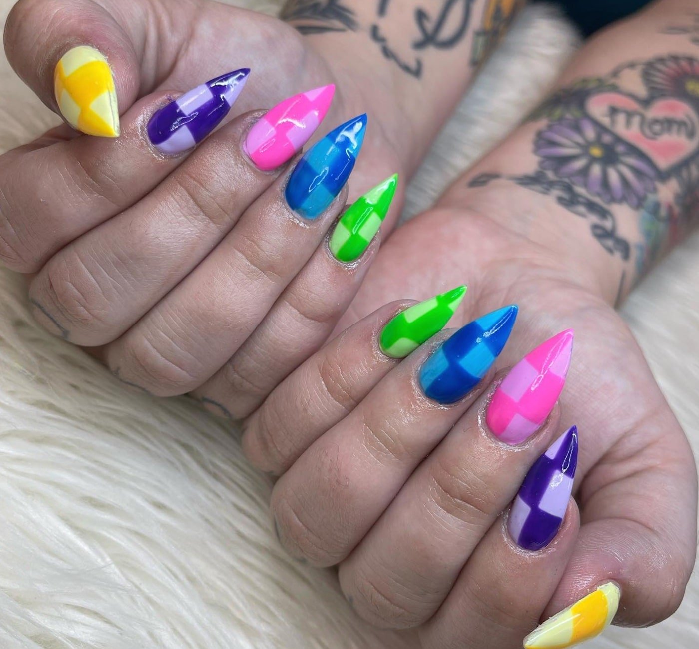 Nails with a checker patter n on them and each nail is a different color tone. So the thumb is two shades of yellow and the pointer is two shades of purple and so on.