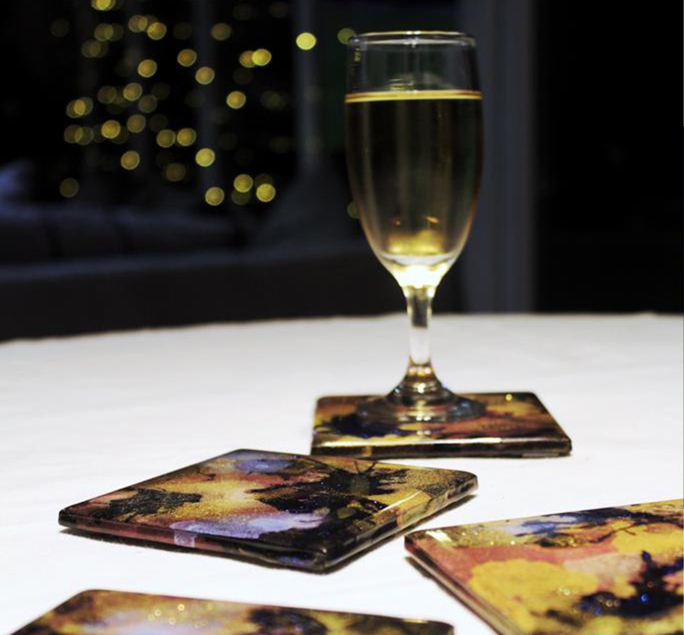 Yellow and black  coasters with champagne glass on it