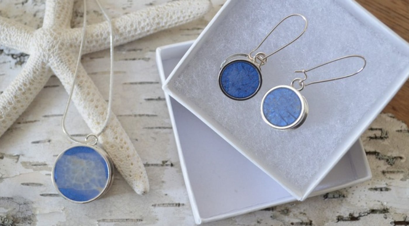 Blue resin dangling earrings in a white box
