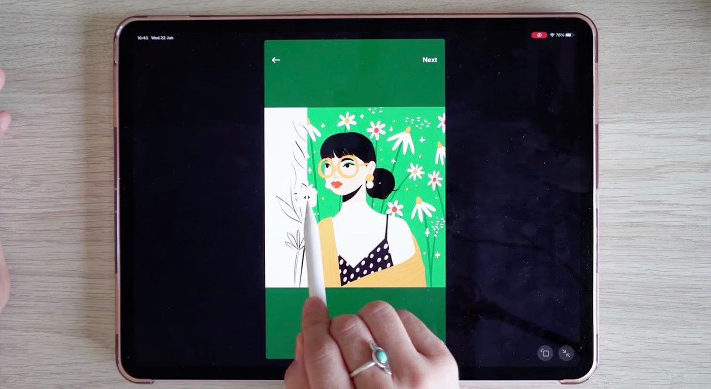 An overhead shot of teacher Charly Clements working on her iPad. On screen, there’s a drawing of a woman with glasses and dark hair in front of a green background, and Charly is dragging her Apple Pencil across the drawing, leaving the linework but removing the color.