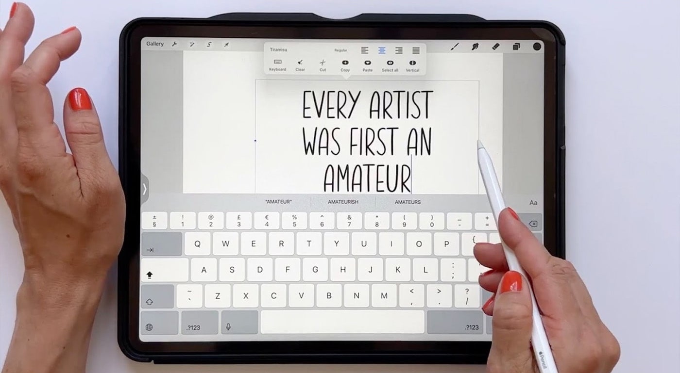 Teacher Maja Faber designs a font on her iPad. It’s an overhead shot, so all that’s visible in the shot is her hands and the screen, on which “Every artist was first an amateur” is written in her hand-drawn font. 