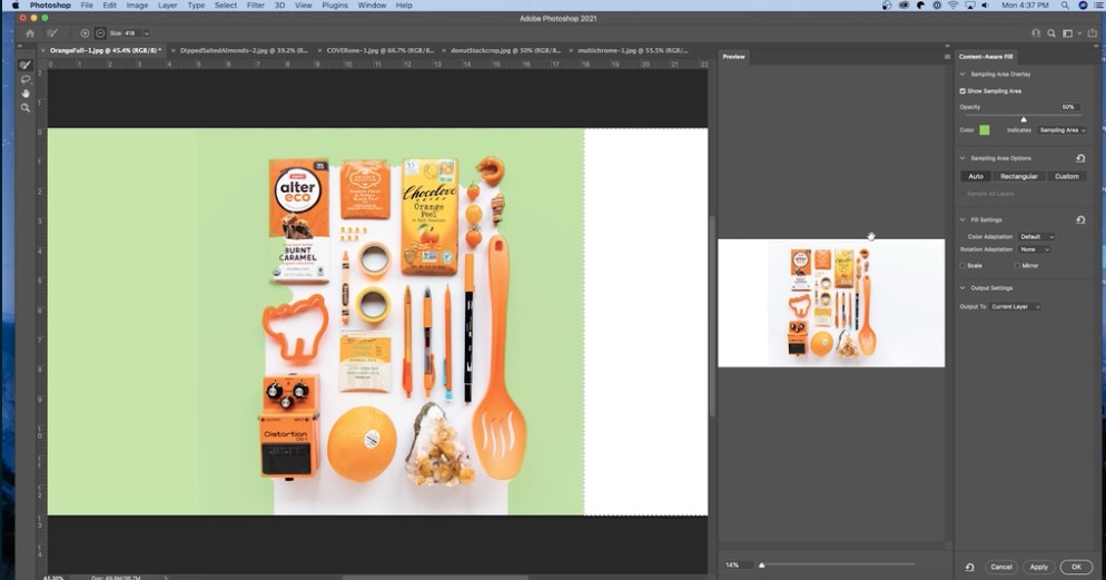 Editing a pixelated photo of orange objects on a table in Adobe Photoshop.