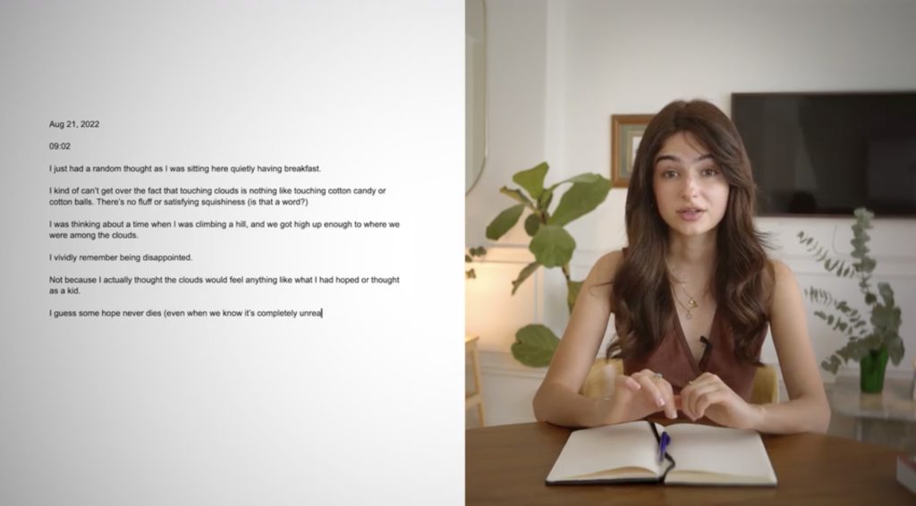 A split screen view; on the right hand side is the text of a journal entry from August 21, 2022. On the right hand side, a woman with dark hair sits at her desk, in front of her open journal, looking at the camera.