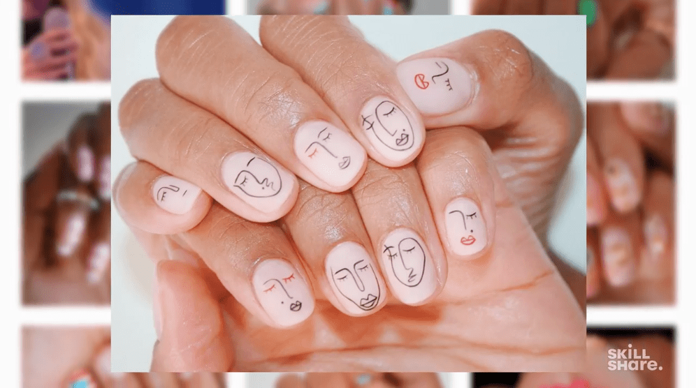 Nails with line art face designs on each, showing how even the most delicate designs can be unique and beautiful.
