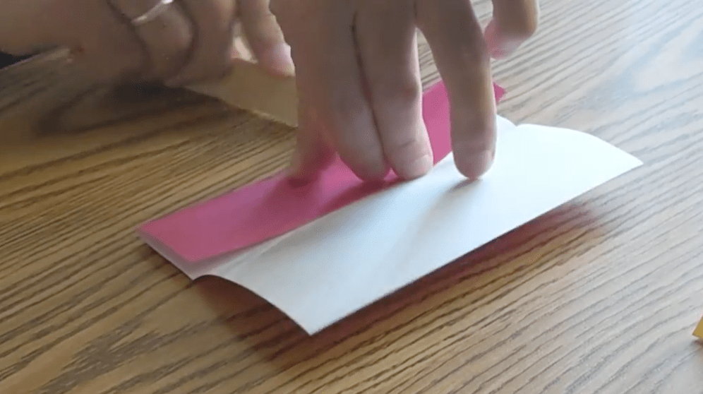 Using an ice cream stick or ruler can help keep your paper folds even as your work.