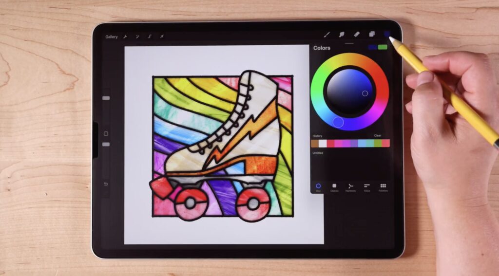 An iPad on a wooden table, displaying a Procreate file. The file is an illustration of a stained glass window in the shape of a roller skate.