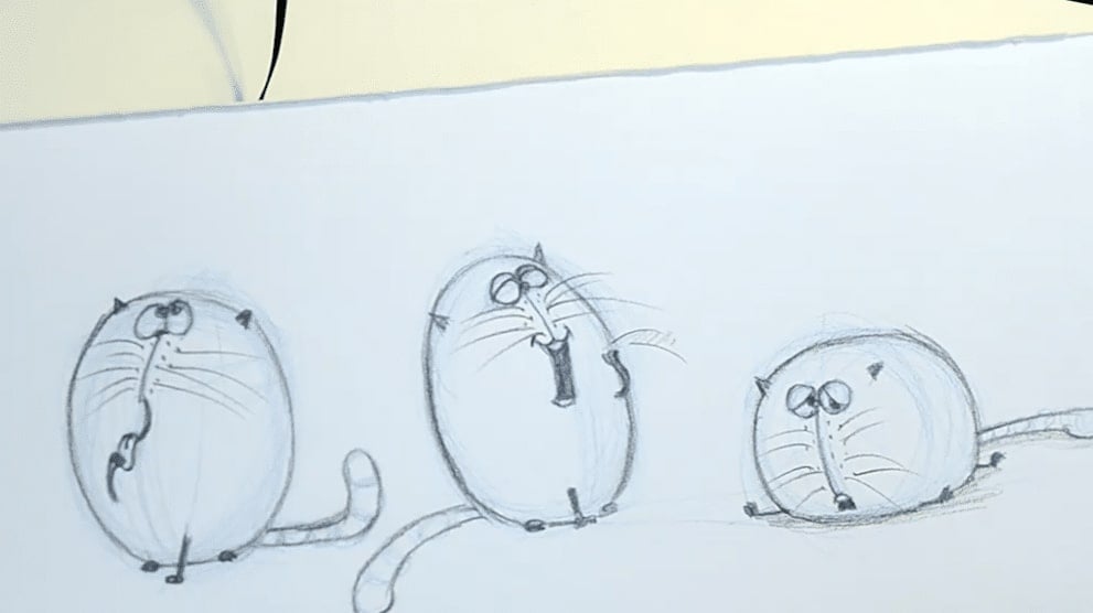 Three cartoon cats drawn in pencil, each with a different facial expression from laughing to sad.