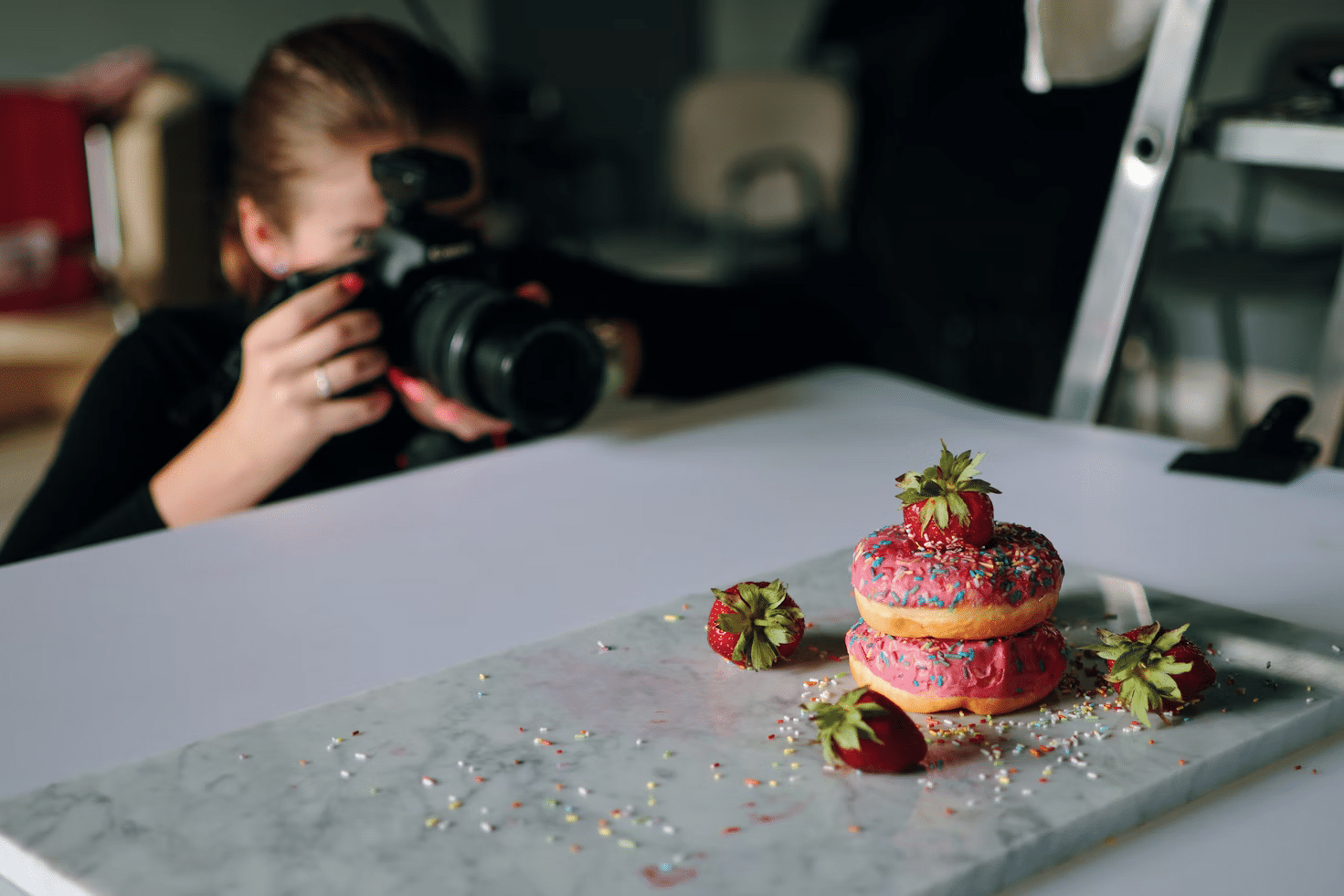 lady photographing donuts