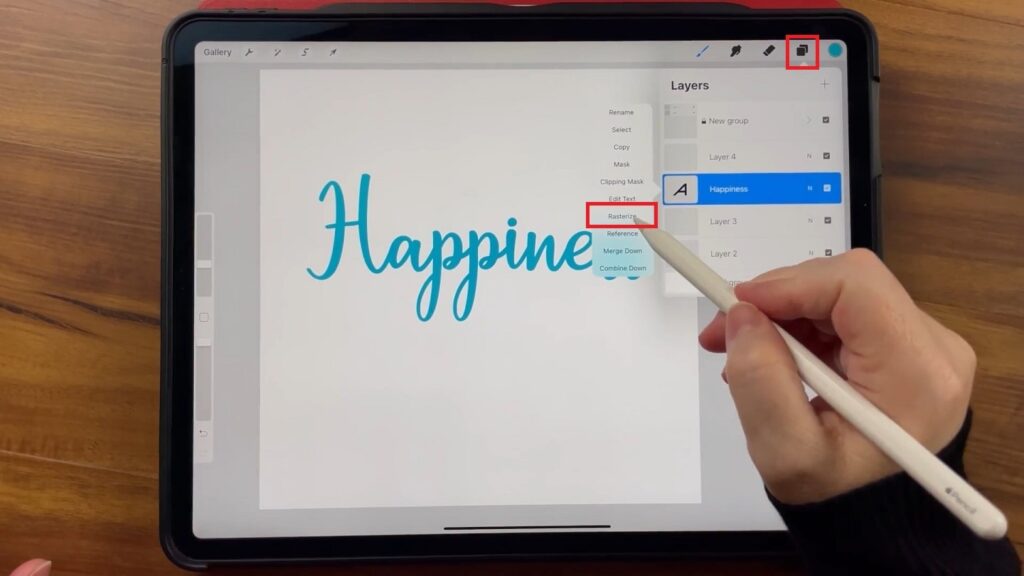 Nichols has the Procreate app open on the iPad, demonstrating how to rasterize a text layer.