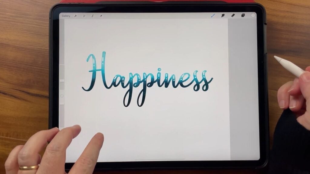 Nichols has the Procreate app open on the iPad, showing an example of how rasterized text can be further customized with brushes and effects.