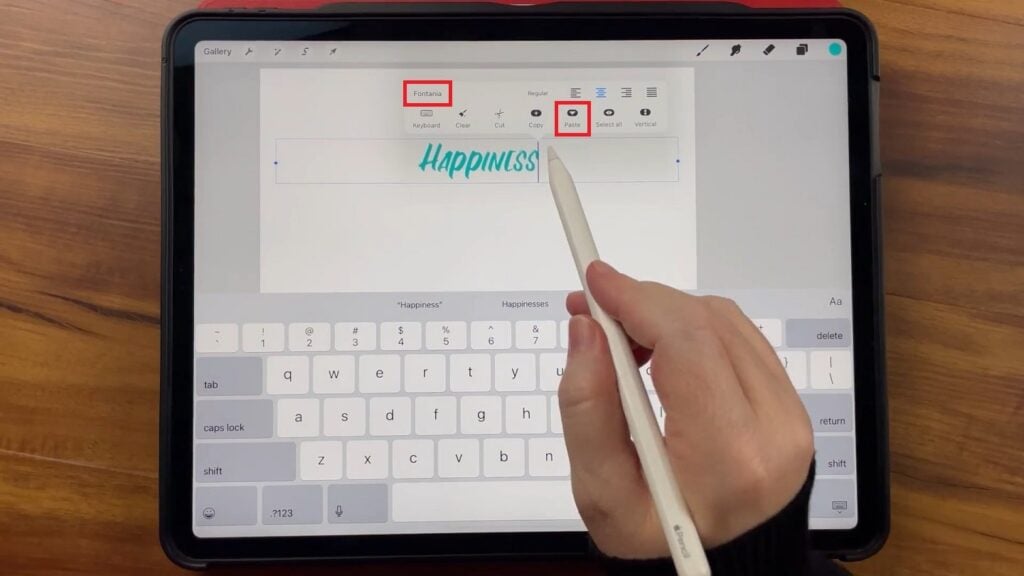 Nichols has the Procreate app open on the iPad, demonstrating the Text Entry Companion.