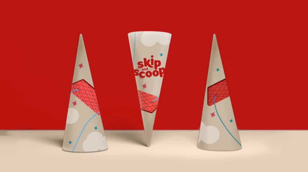 Three conical ice cream cone wrappers on a white tabletop in front of a red background. The wrappers are branded with the words ‘skip and scoop,’ and feature illustrations of clouds, sparkles and swings.