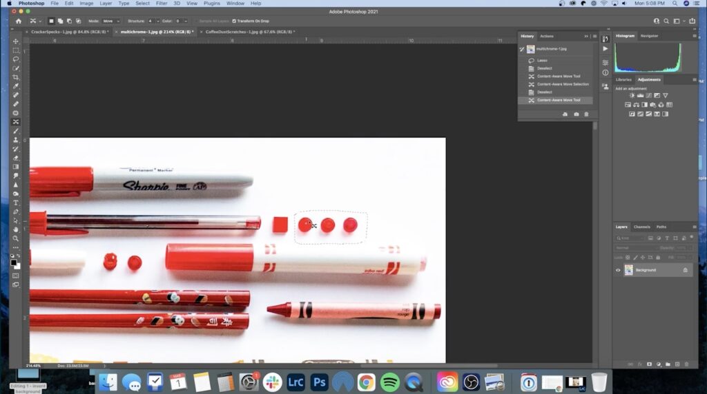 Adobe Photoshop is open to an image of red writing utensils lined up next to a few red legos. Three of the little red legos are selected. 