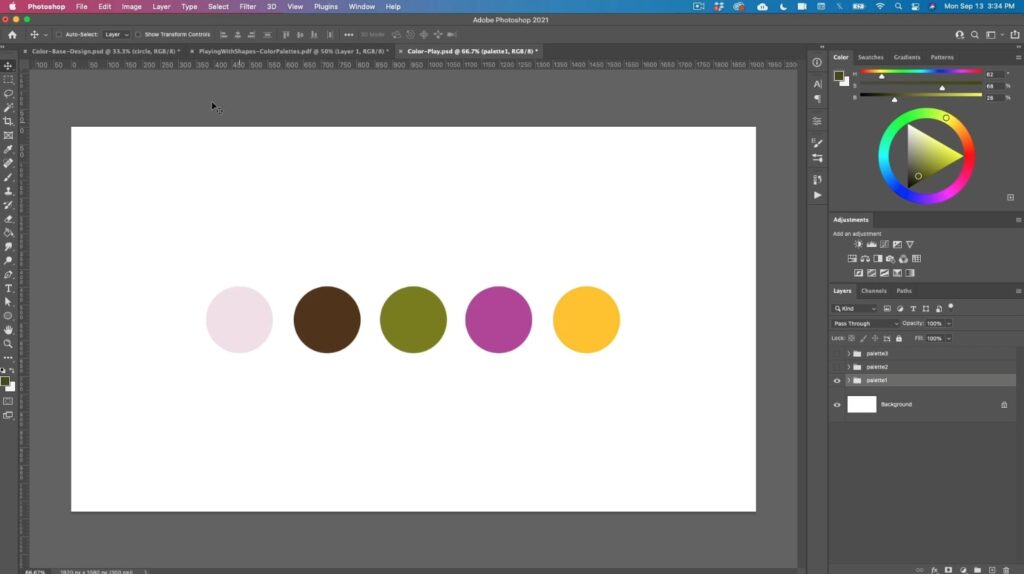Adobe Photoshop is open to a blank canvas with five different colored circles on it including light pink, dark brown, olive green, fuschia and dandelion yellow. 