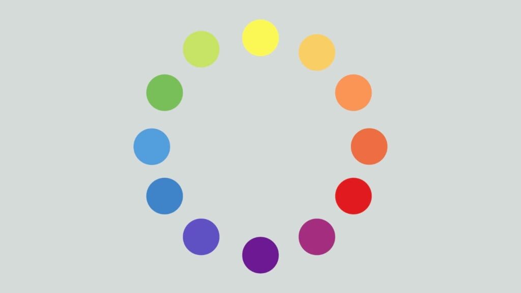 A color wheel with 12 dots, each depicting a different color, is presented on a light gray background. 