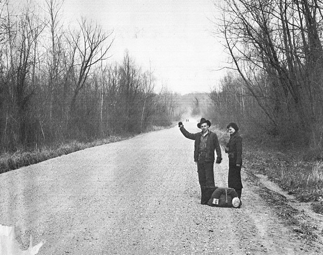 black and white men on side of street
