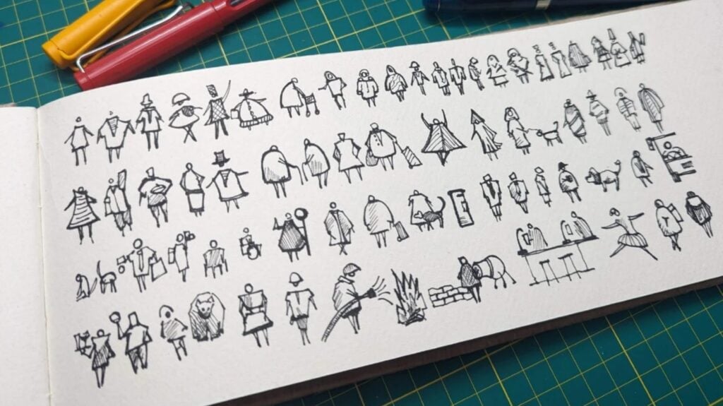 A wide piece of white sketching paper laying on a green cutting mat. The paper is filled with dozens of small doodles of people.
