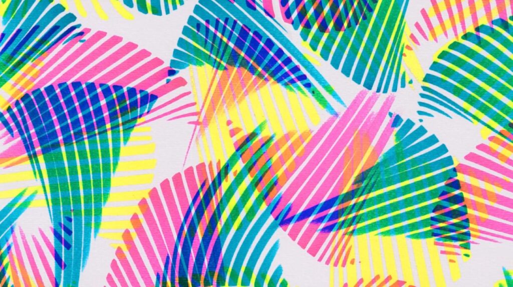 An abstract design created with neon highlighters on a white background. The design resembles tropical leaves. 