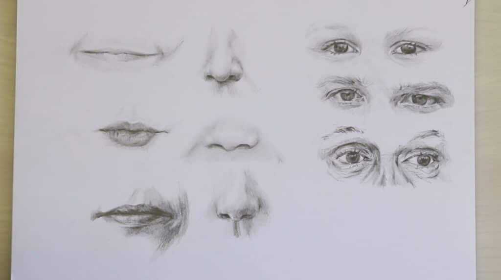 A white piece of paper filled with three sketches of mouths, three of noses and three of eyes.