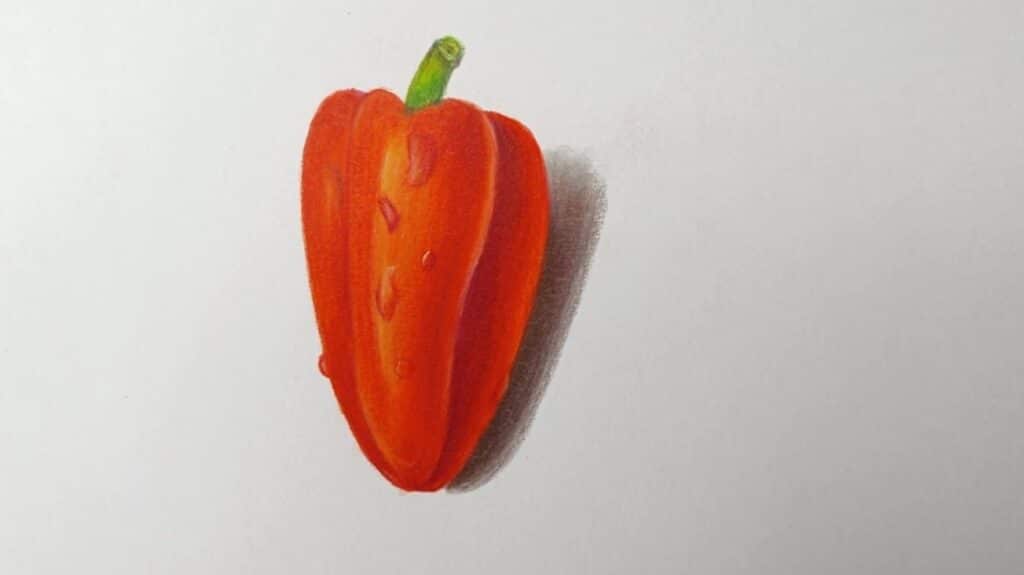A realistic drawing of a red bell pepper with a green stem, done in colored pencils on a white piece of paper.