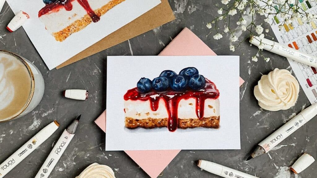 A realistic illustration of a slice of blueberry cheesecake on white paper. The paper is laying on a gray stone tabletop.