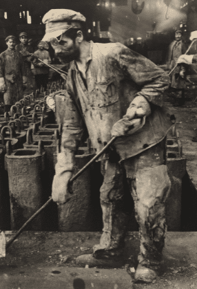 black and white photo of man shoveling