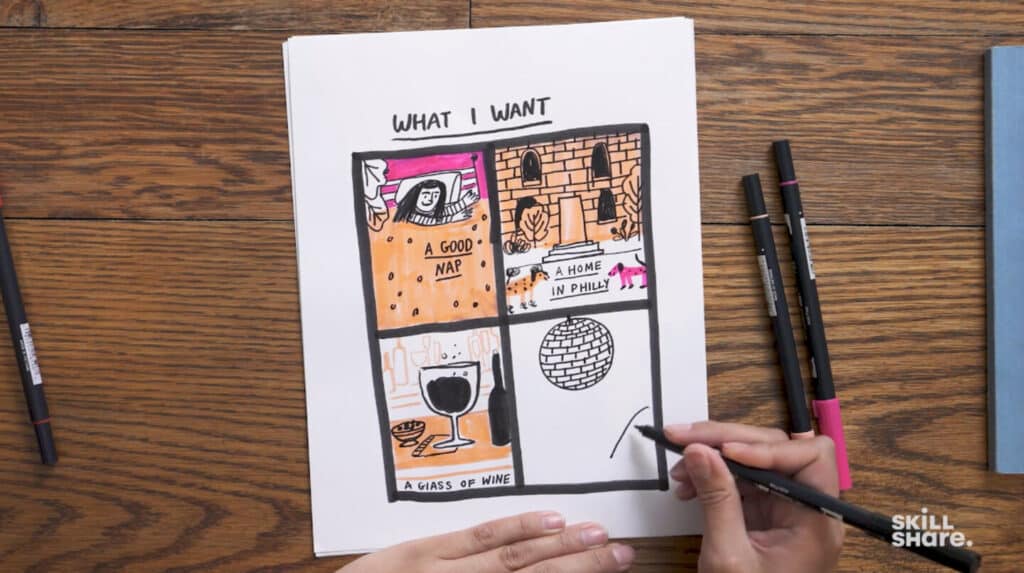 A woman’s hands drawing on a piece of paper lying on a brown wooden tabletop. The paper is titled ‘What I Want’ and has four illustrations on it, each in its own box. One says ‘a good nap’ and depicts a woman laying in bed, one says ‘a home in Philly’ and depicts two dogs in front of steps and a door, one says ‘a glass of wine’ and depicts a glass of wine on a table, and one depicts a disco ball.