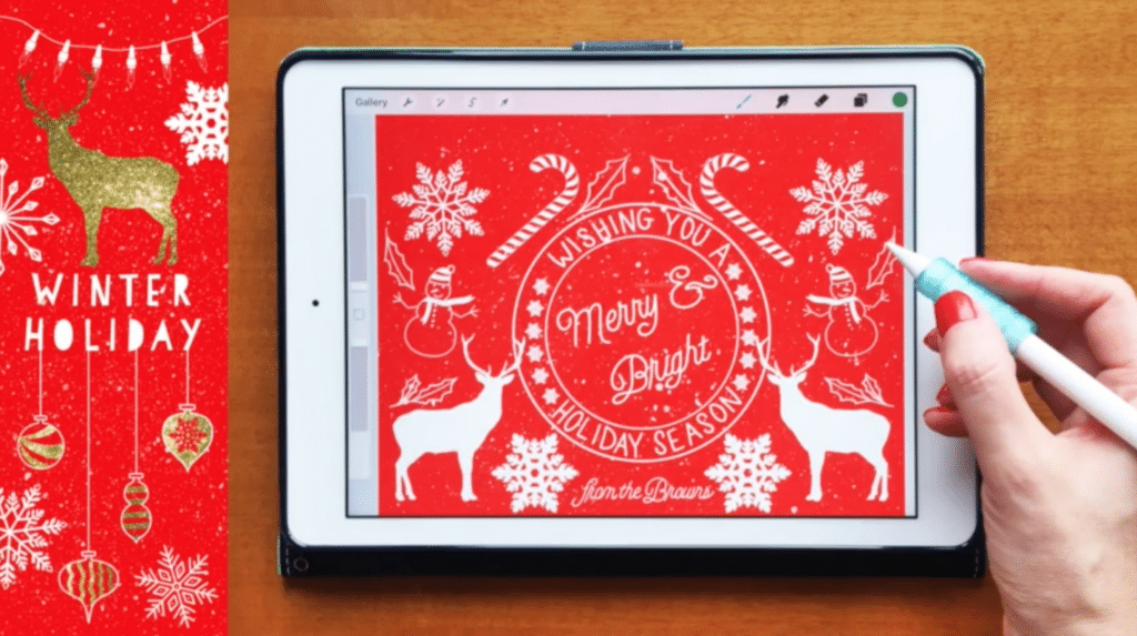 An iPad sits on a wooden table. To its right, there is a hand holding an Apple pencil. To its left, there is an illustration of snowflakes and the words “Winter Watercolors.” The iPad is open to the Procreate app and shows a holiday illustration of blue snowflakes.
Caption: Get inspired by watercolors and a winter color palette while drawing these snowflakes in Procreate.