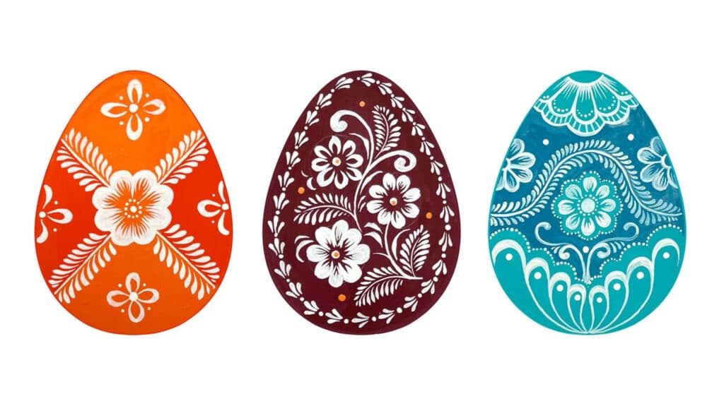 Three brightly colored Easter eggs with folk art designs.