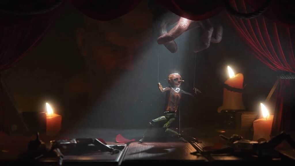 A small marionette dances on a stage lit by candles and a spotlight–behind it is the marionettist with his fingers holding the puppet strings.
