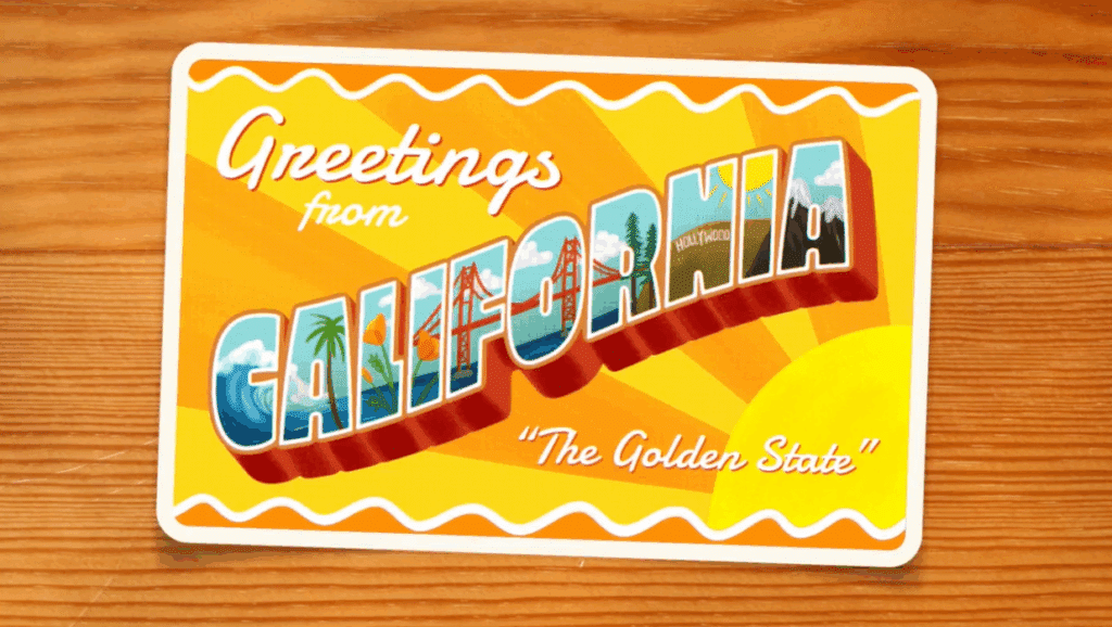 A vintage-style postcard from California sits on a table.