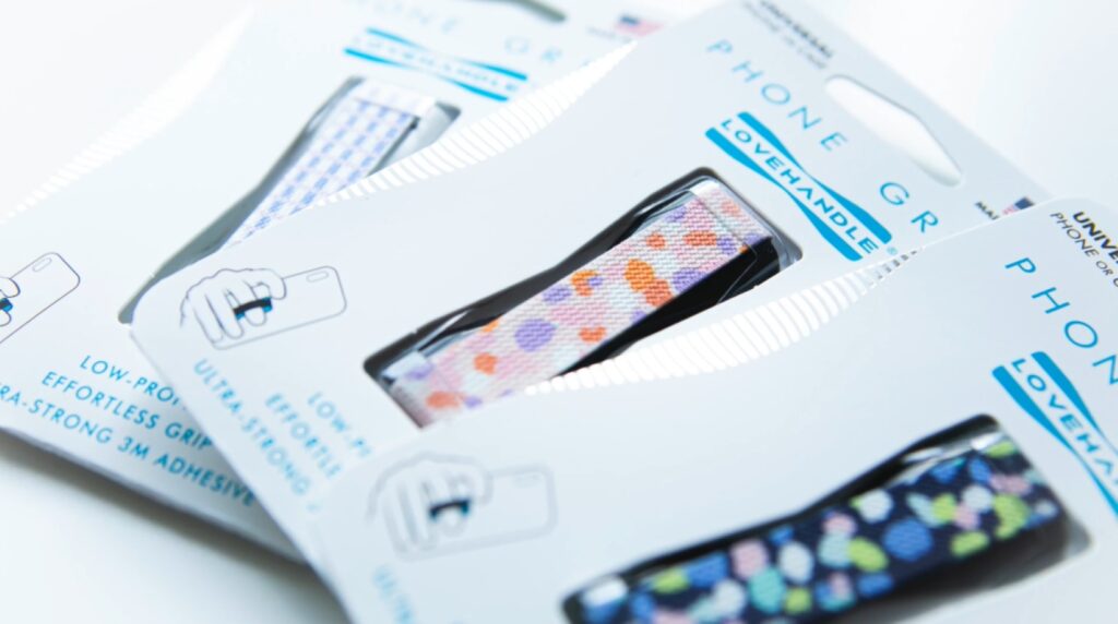A close-up photo of patterned fabric phone grips called ‘lovehandles.’ 