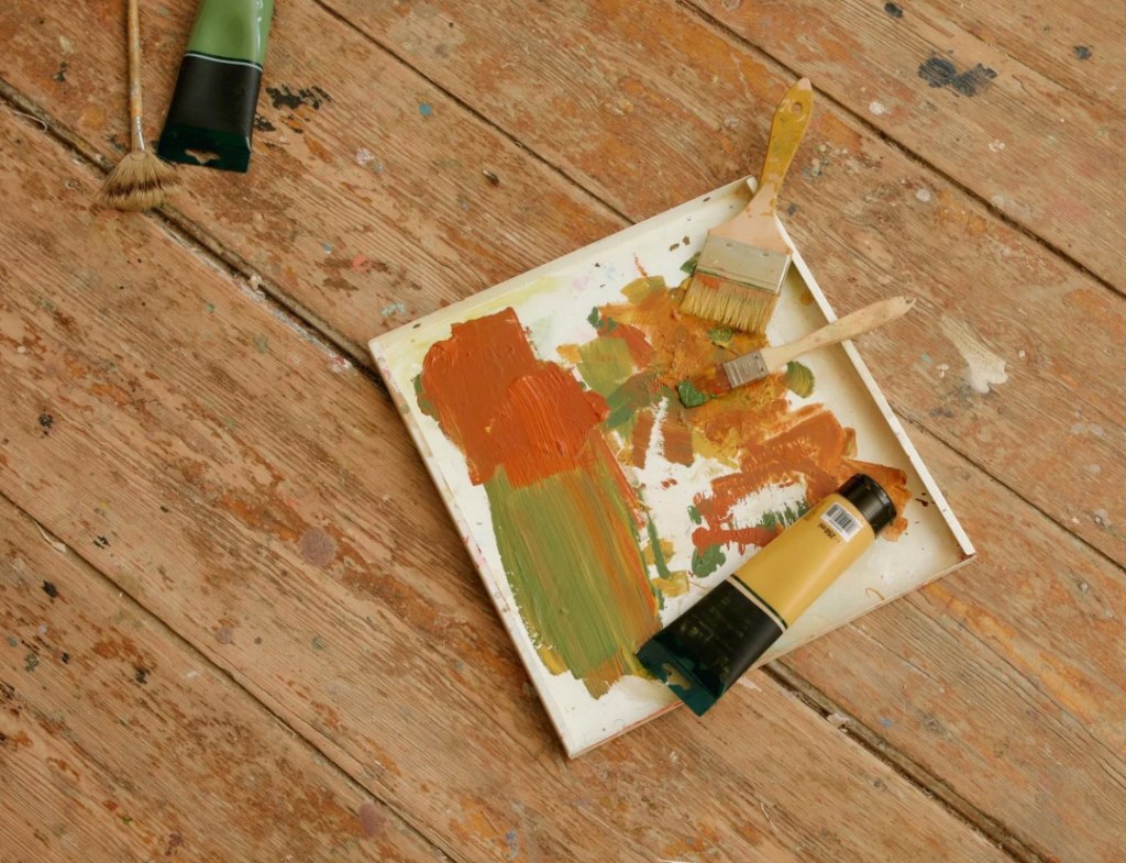 palette with swatches of paint and a paintbrush
